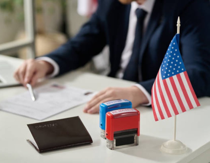 Close up of approved and rejected stamps on table in US immigration office with flag, copy space